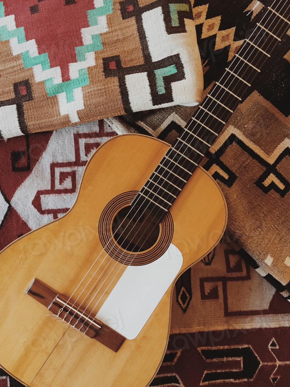 An acoustic guitar and tribal